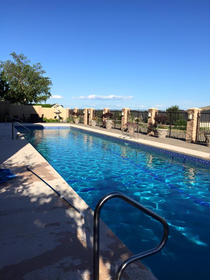 Long rectangular pool maintained by Pool and Spa Solutions